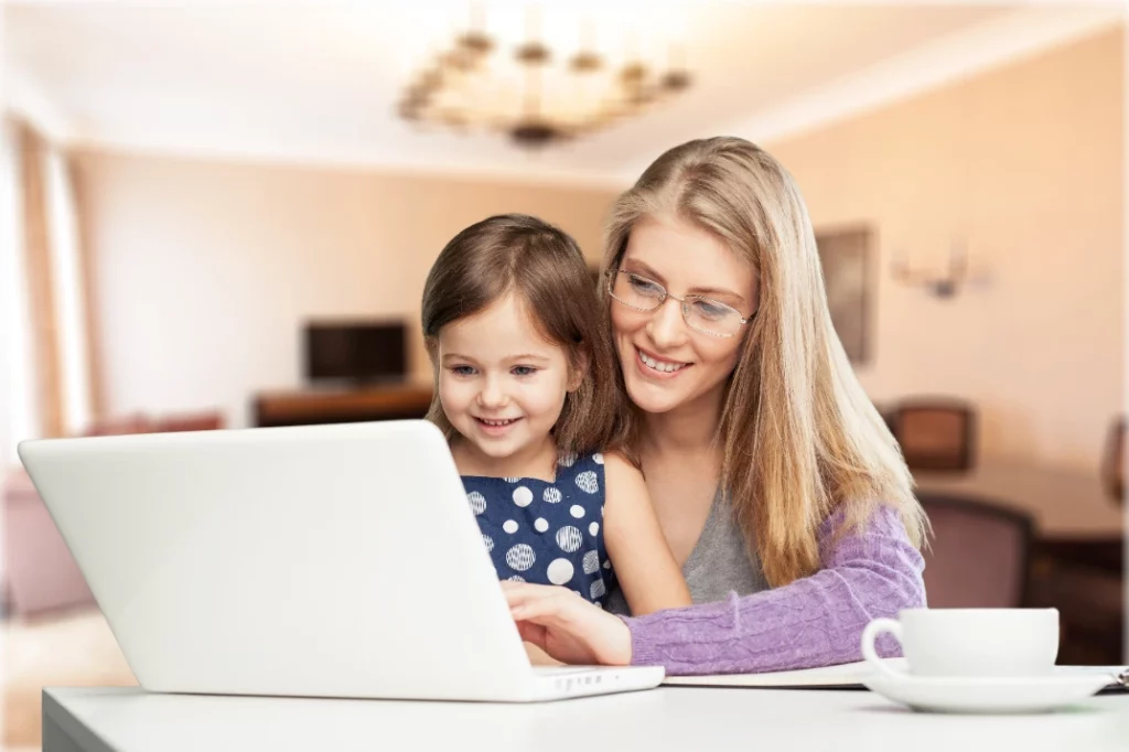 Aetna member with her child looking at laptop during parenting online therapy in Fresno California