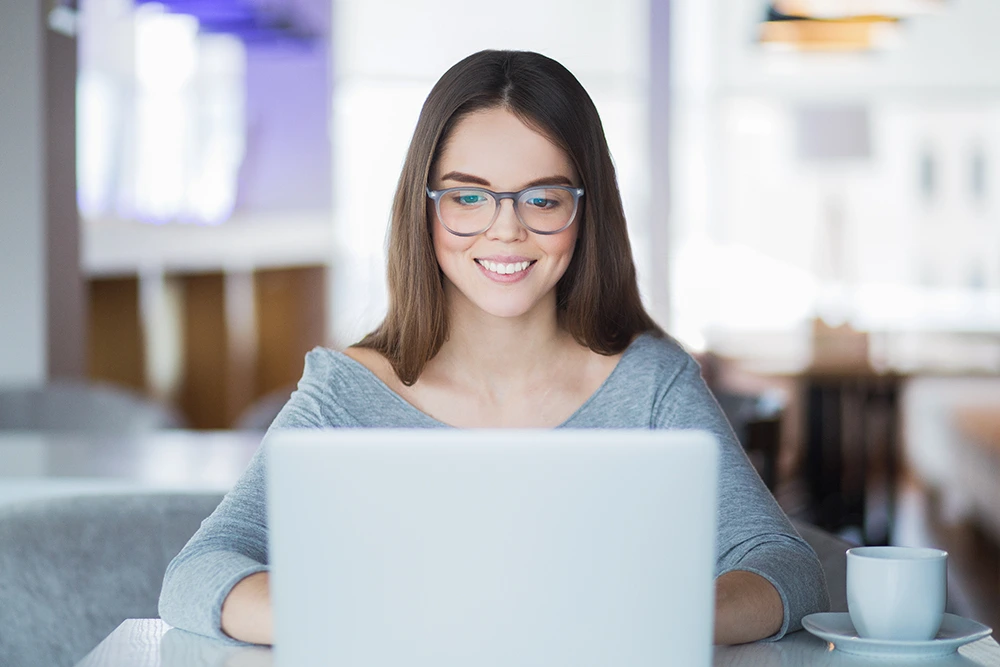 woman with anxiety and Aetna insurance in Los Angeles California during virtual therapy session sitting at her laptop wearing glasses